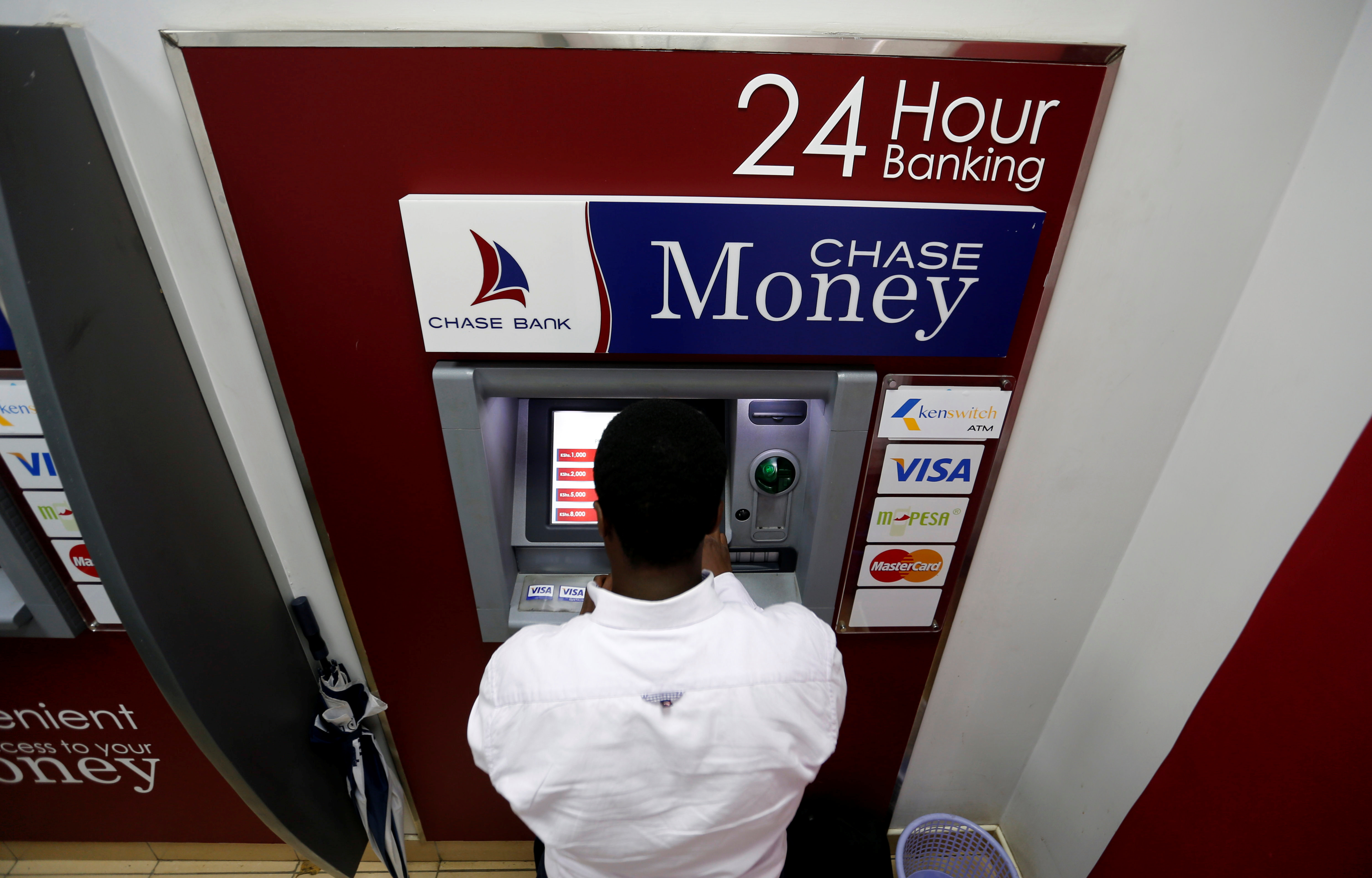 A man uses an ATM at a Chase Bank branch, now managed by Kenya Commercial Bank after its reopening in downtown Nairobi